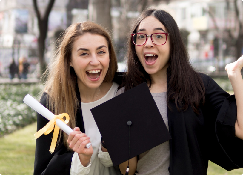 Two graduates holding a diploma